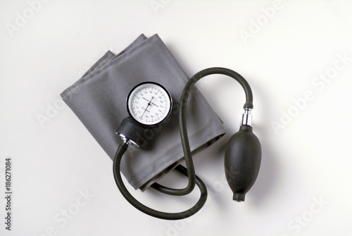 Blood Pressure Cuff on White Background. Also known as a sphygmomanometer it is used to measure the blood pressure of patients in a medical environment.