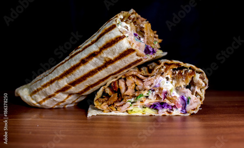 dürüm döner kebab on a wooden surface