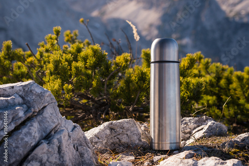 Thermos Vacuum flask in the mountains