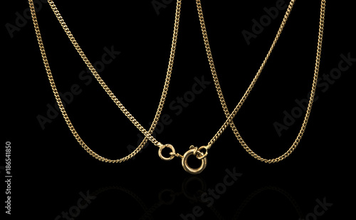Unique gold necklace isolated on black background, macro closeup showing yellow chain links detail
