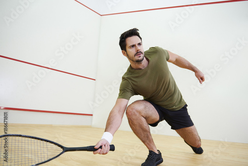 Man during squash match on court.