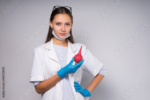 Young girl doctor with enema