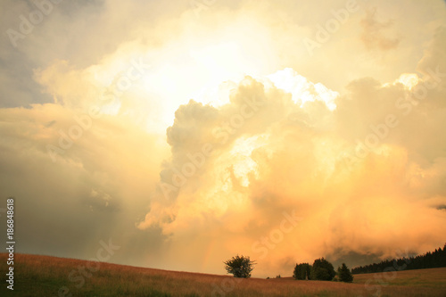 Dramatic sky with big clouds above Pasterka village in Table Mountain in Poland. Stormy weather, natural armagedon.