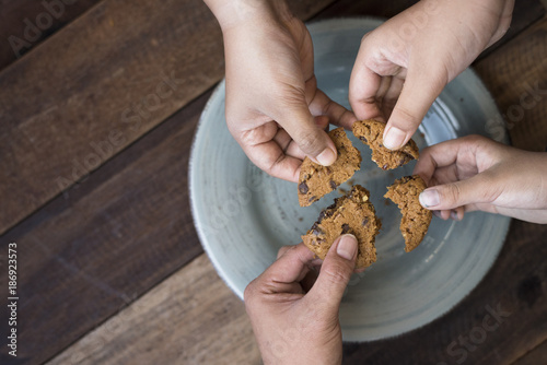 sharing concept - family sharing cookies