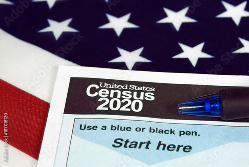 close up of 2020 census document form and ballpoint pen on American flag