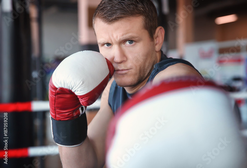 Young man training in boxing ring