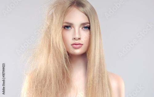 Hair care . Straightening ,smoothing and treatment of the hair . Girl with straight and smooth hair on one side of the head . The second side of the head tangled and unbrushed hair . 