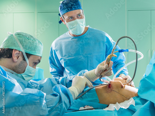 Real surgery team in the operating room. Photos from a live session of breast augmentation surgery.