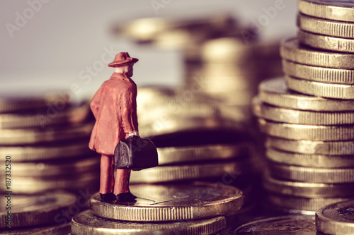 miniature traveler on a pile of euro coins