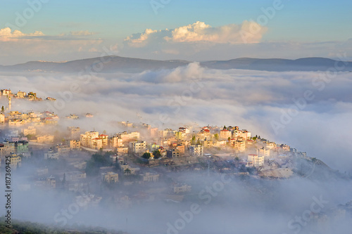 biblical village Cana of Galilee ( Kafr Kanna ) in morning fog, Nazareth in Israel
