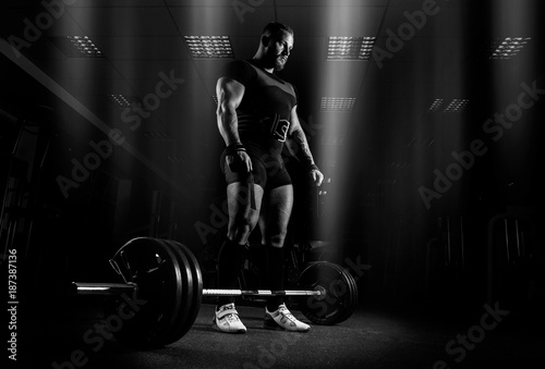 The weightlifter is preparing to perform an exercise called deadlift.