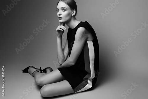 high fashion woman in short black dress.