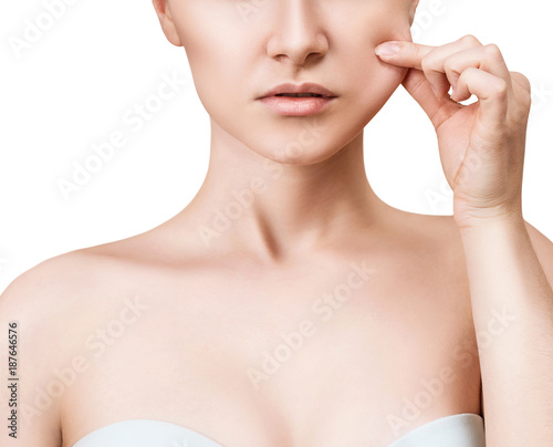 Young woman pulls cheek's skin.