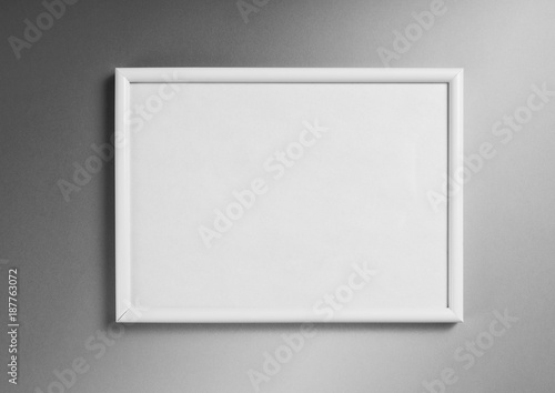 White frame for paintings or photographs on gray background.