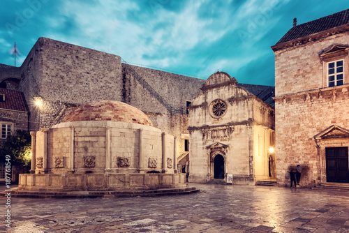 Old City of Dubrovnik. Historical town square with big Onofrio fountain, church and the entrance to the city wall, UNESCO World Heritage site, Croatia