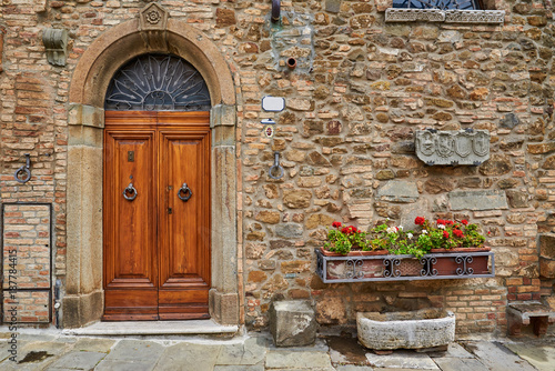 Flowery streets on spring day in a small magical village Pienza, Tuscany.
