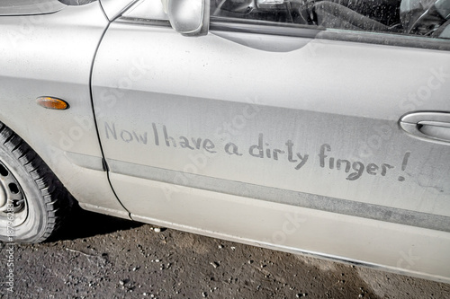 Dirty car on the street with the inscription Now I have a dirty finger.