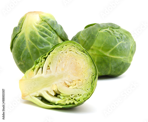 freshly brussel sprouts and some whole ones on a white background