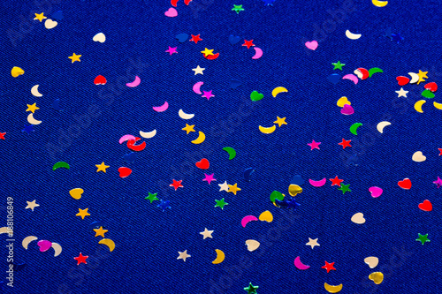 Blue sparkling and glitter background witl little hearts, stars and moons. Top view.