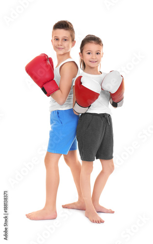 Cute little children in boxing gloves on white background