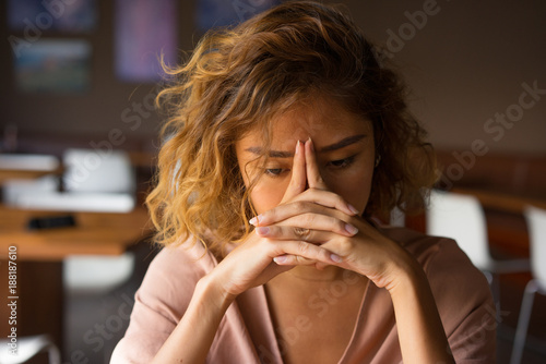 Tired Young Woman Leaning Head on Hands