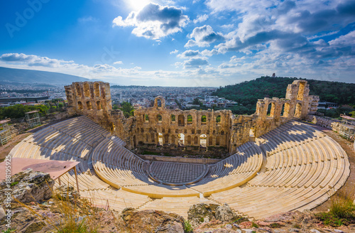 Odeon of Herodes Atticus, an ancient Roman and Classical Greek theater on the Acropolis slopes, near the Parthenon, with rows of circular seating and stone structure backlit by the sun, Athens, Greece
