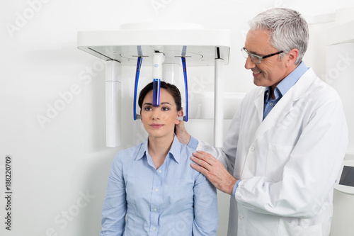 A dentist with his patient doing an x-ray panoramic digital