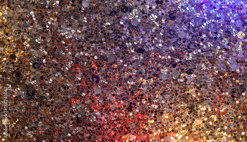 sequins reflecting coloured lights background