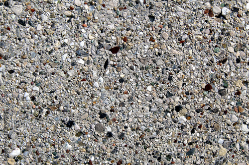 Smooth surface of an artificial conglomerate rock concrete cement wall