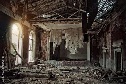 Old creepy abandoned rotten ruined haunted theater, a ragged curtain