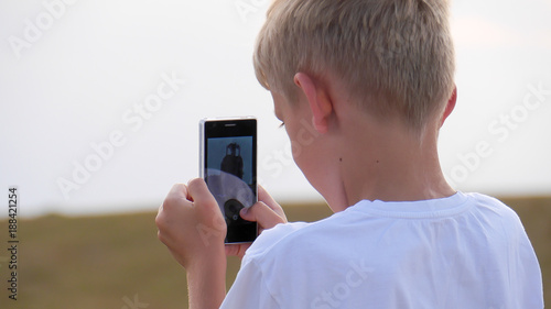 excited boy using smartphone