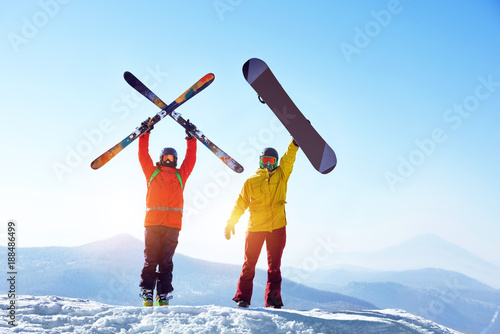 Active skier and snowboarder against mountains