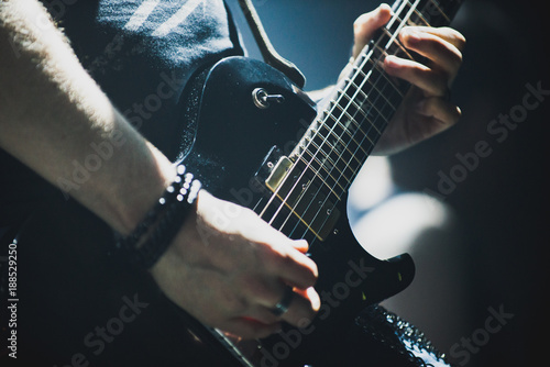 Close up of lead guitarist performing a solo on stage during concert