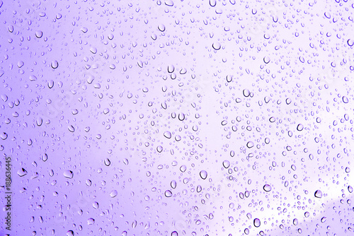 Water drops of pink on glass.