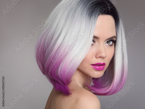 Colored Ombre hair extensions. Beauty Model Girl blonde with short bob purple hairstyle isolated on gray background. Closeup woman portrait.