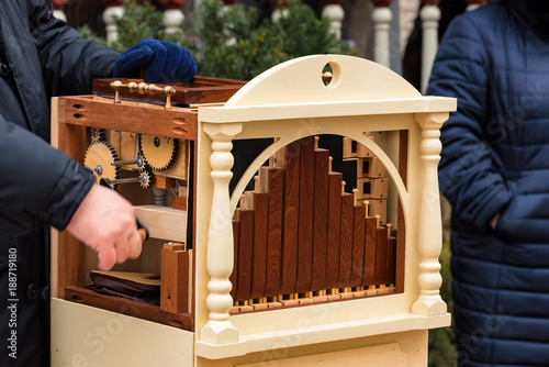 Male hands on barrel organ in street