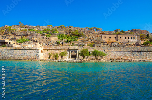 View of the island of Spinalonga with calm sea. Here were isolated lepers, humans with the Hansen's desease, gulf of Elounda, Crete, Greece. 
