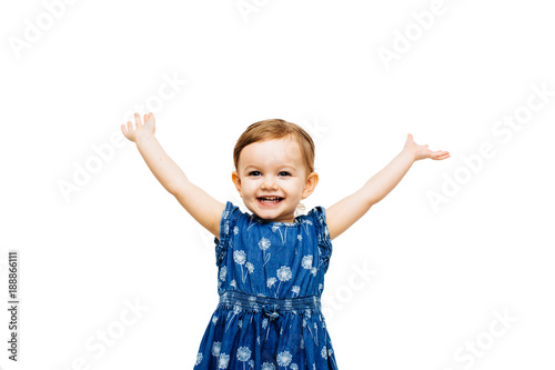 Studio portrait of smiling girl with arms raised