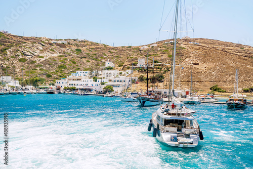 A yacht heads towards the port on the Greek island of Ios. Stunning turquoise waters of the Greek Islands.