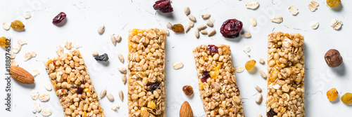 Granola bar with nuts, fruit and berries on white.