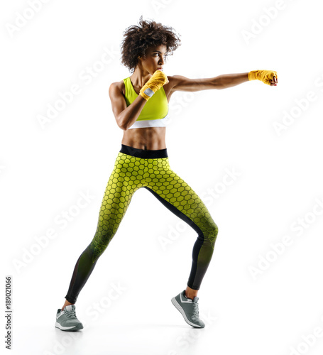 Sporty woman during boxing exercise making direct hit. Photo of boxer on white background. Strength and motivation