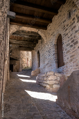 Stone paved covered alley in the Medieval village of Caldarola, Italy