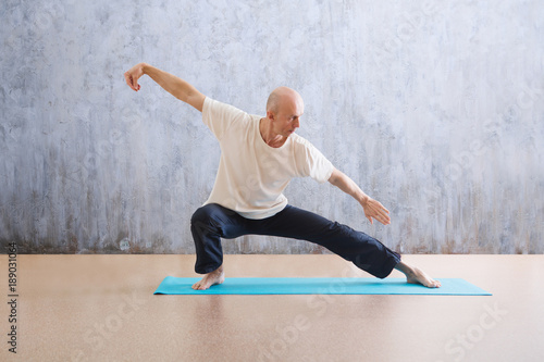 man praticing tai chi chuan in the gym. Chinese management skill Qi's energy. WU-SHU.