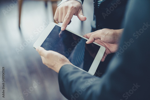 Businessman use computer tablet for work in communication around worldwide to success marketing plan of company