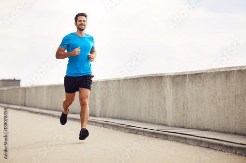 Athletic young man running