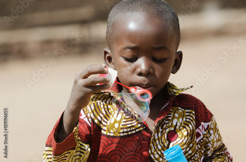 African black boy Blowing Bubbles Outdoors