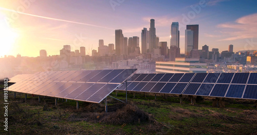 photovoltaic panels on sunrise front of the big city