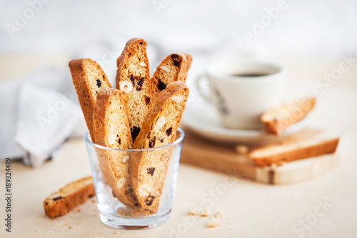 Italian cranberry almond biscotti and cup of coffee on background