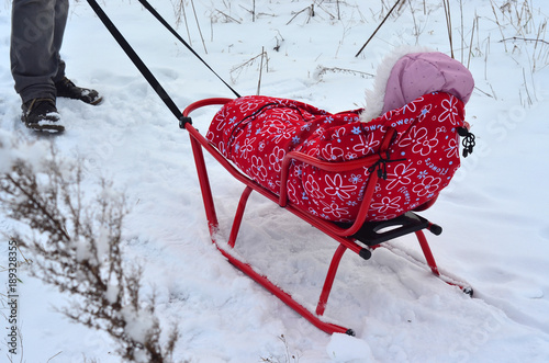 Child sledding in winter in fresh air