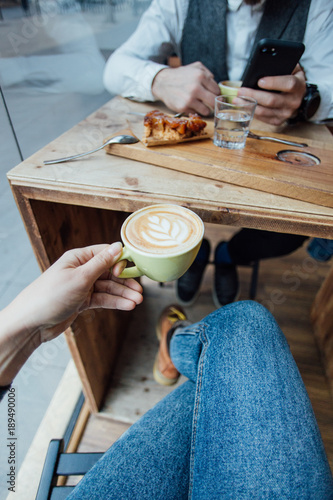 POV shot of woman holding coffee cup during date or meeting with friend or boyfriend, beautiful and inspiring beverage drink image, healthy hipster lifestyle